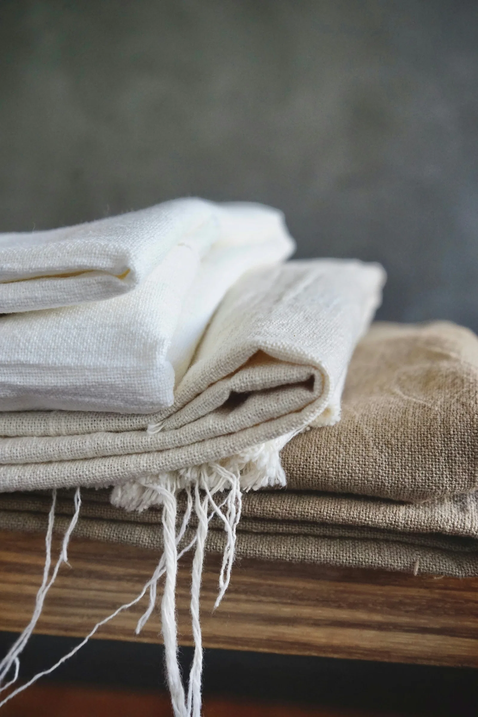 Gefaltete Leinentücher in Weiß, Beige und Braun mit Fransen für eine natürliche Einrichtung im Ethno- und Boho-Stil