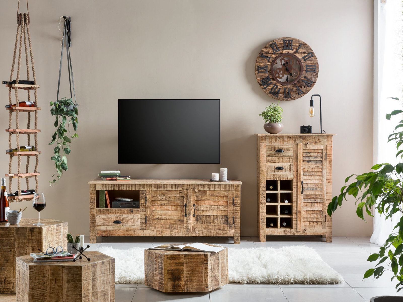Wohnbeispiel mit sechseckigem Couchtisch Caribou 3er-Set aus lackiertem Mangoholz, 45°-Frontansicht auf Teppich