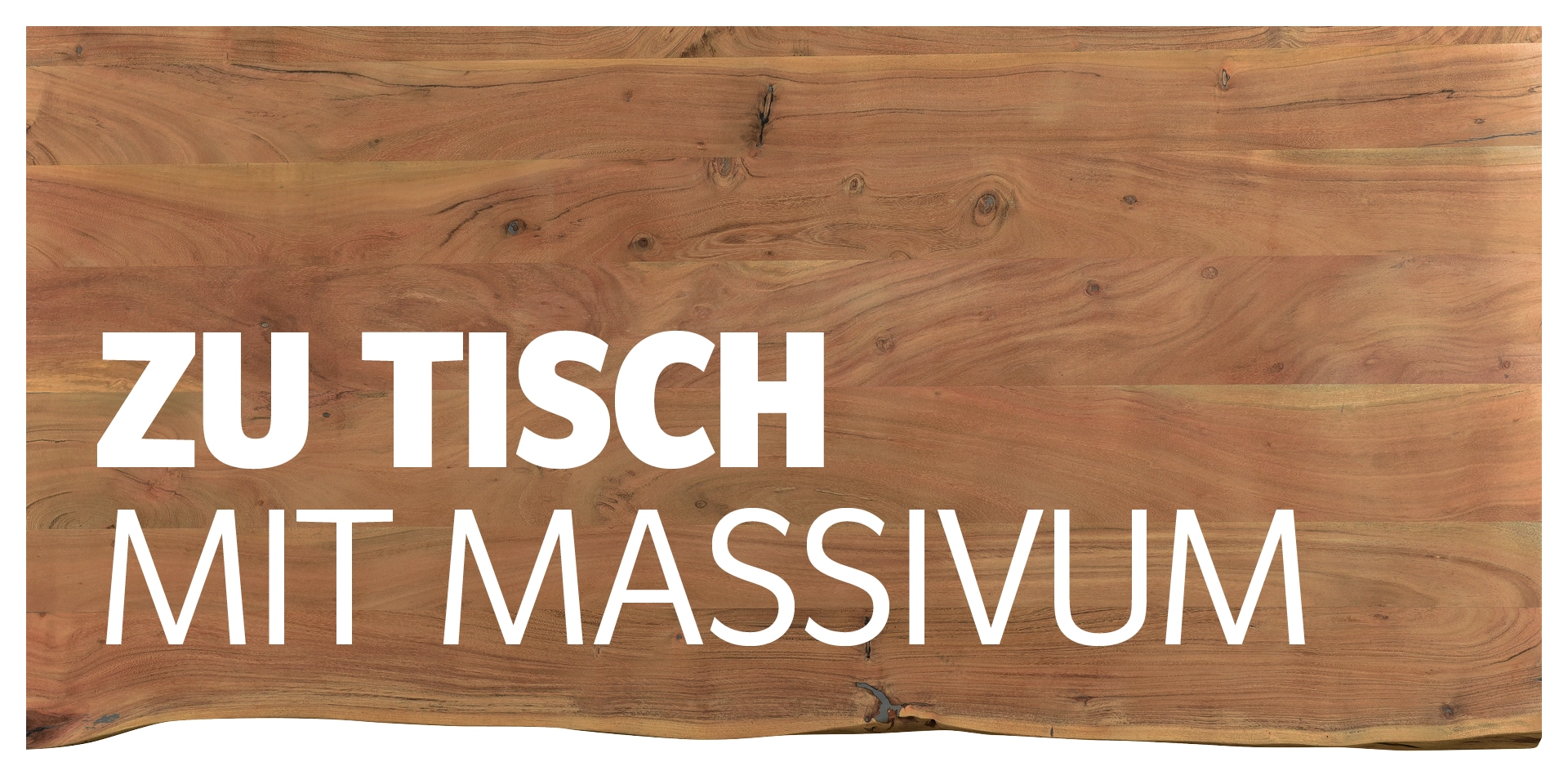 Gedeckter Esstisch aus massivem Holz in warmem Ambiente, Teller, Gläser und Dekoration für gemütliches Beisammensein